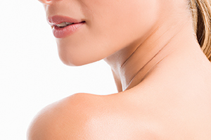 Close-up of a woman's lower face, neck, and shoulder