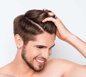 smiling man showing his healthy hair