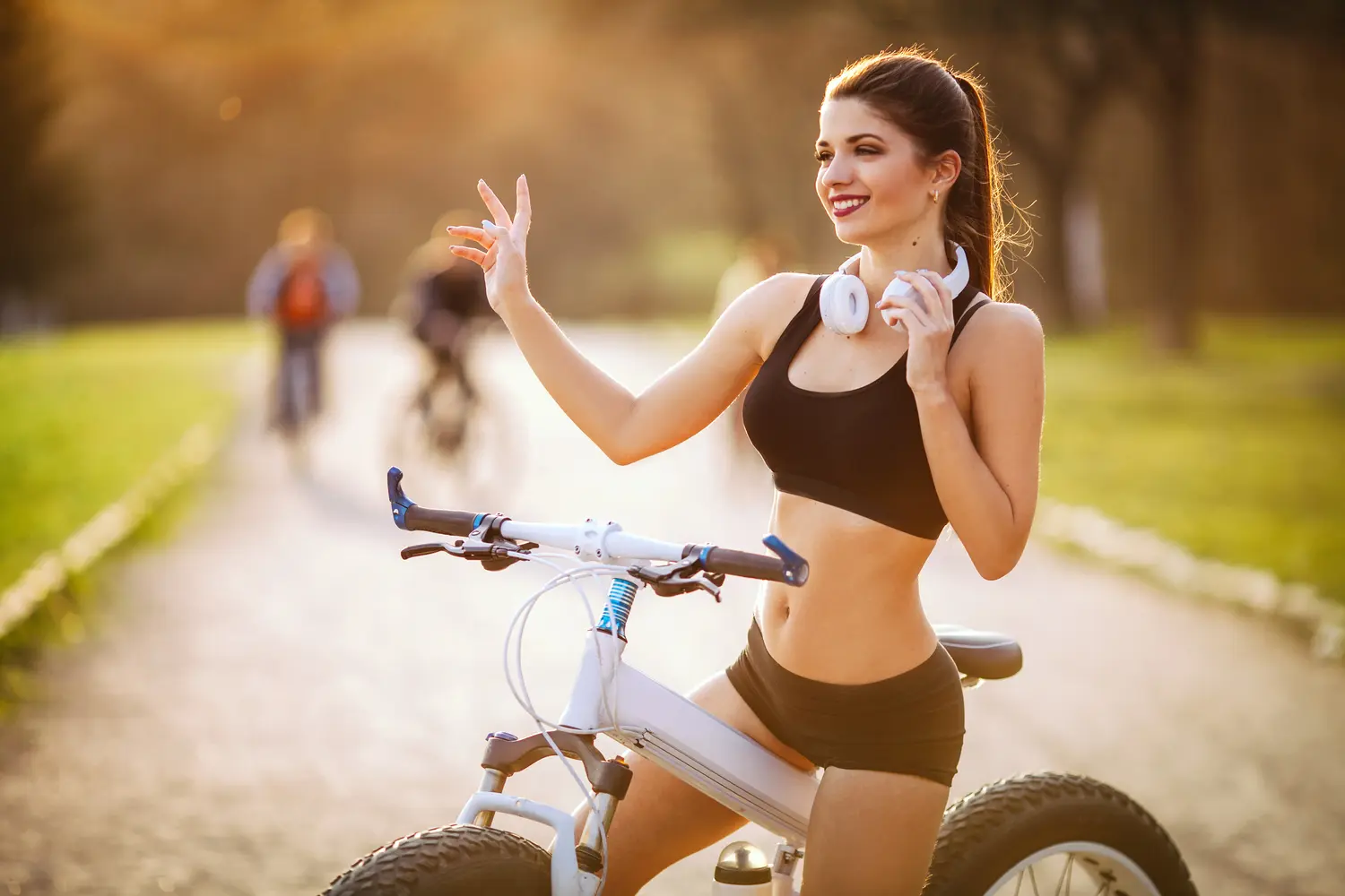joyful girl with a beautiful figure holds headphones